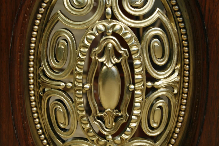 Oval piano legs feature ornate filigree bronze panels