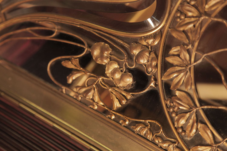 Whiplash lines and stylised foliage and flowers complete the design