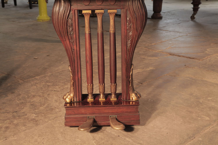 Bluthner two-pedal lyre has three central spindles accented with gilted acanthus and palms at either end. Two gilted lions feet frame the cabriole lyre surround.