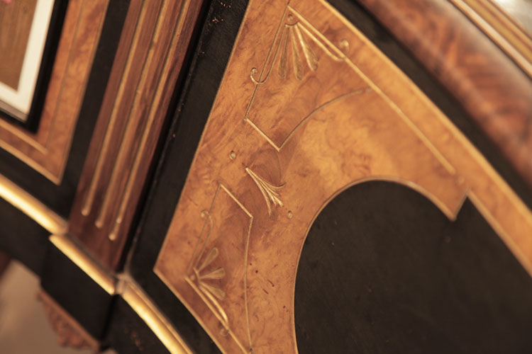 Side cabinet panels in black and burr walnut with carved, gilt embellishment of stylised flowers