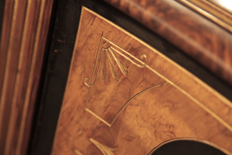 Side cabinet panels in black and burr walnut with carved, gilt embellishment of stylised flowers 