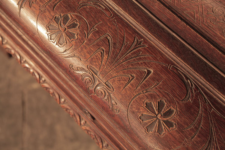 Francke piano fall carved with stylised anthemion and hibiscus flowers 