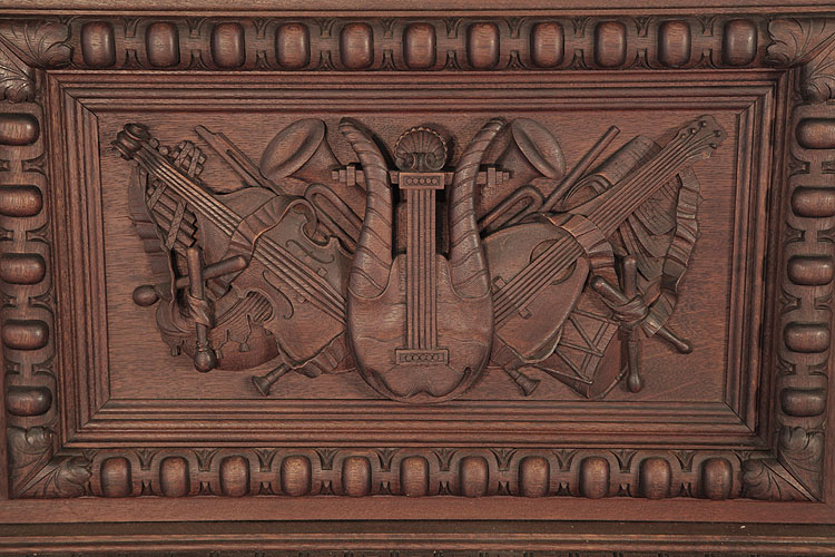 Fortner  front panel carved with musical instruments in high relief
