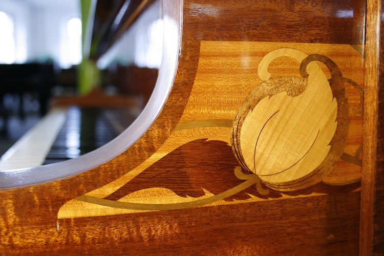 Piano cheek inlaid panel of stylised flowers, leaves and stems in a variety ofcontrasting, exotic woods