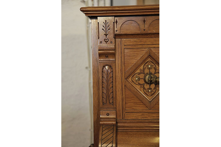 Ibach carved pilaster featuring carved folk art elements including a heart and stylised trees 