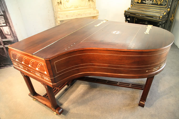 From the side, the piano inlay design is visible.