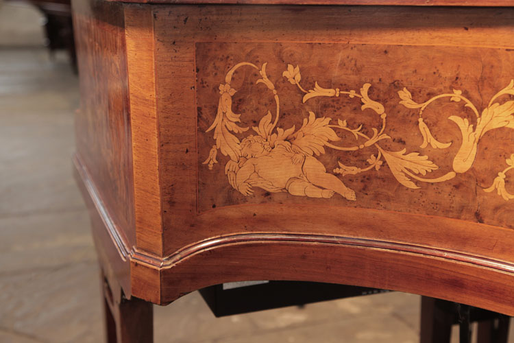 A reclining cherub, sleeps beneath scrolling acanthus tendrils 