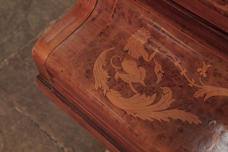 Piano fall inlaid with a figure pulling a tendril of foliage