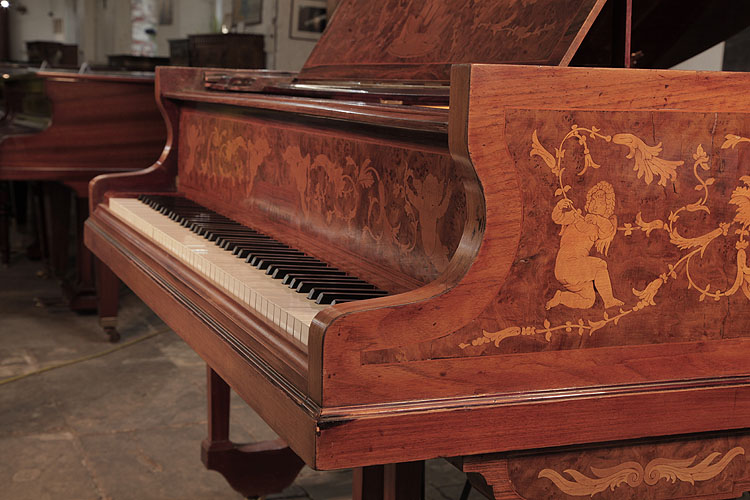 Lipp piano cheek inlaid with winged cherubs, hibiscus and scroling tendrils 