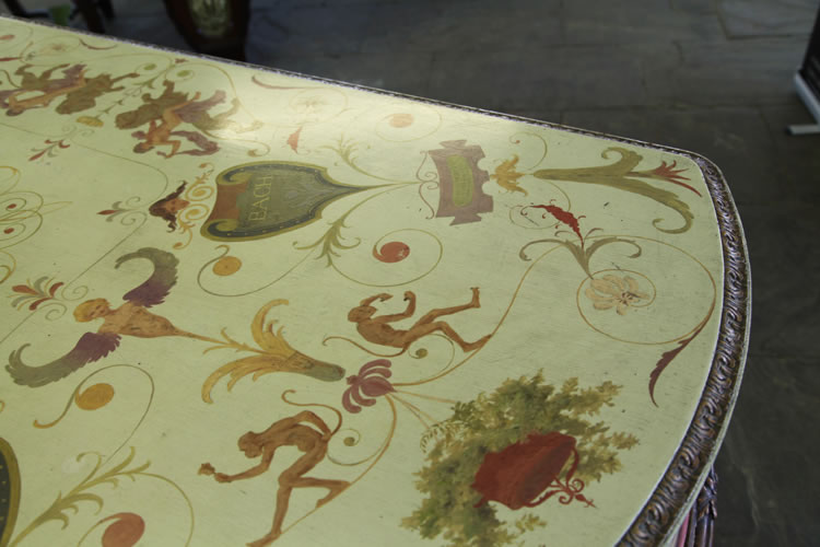 Hand-painted Pleyel piano lid featuring composers names on pelta shields, monkeys, an angelic figurehead, arabesques, flowers and a hanging basket.