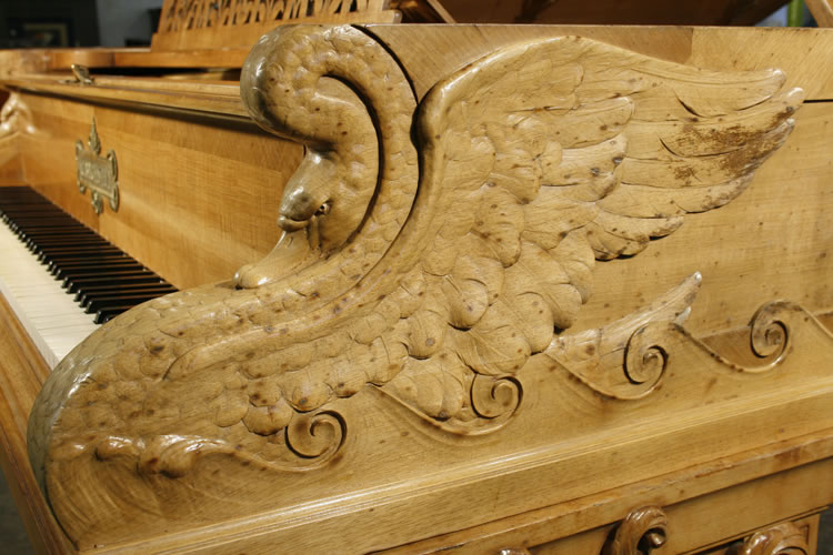 Carved swans on piano cheeks