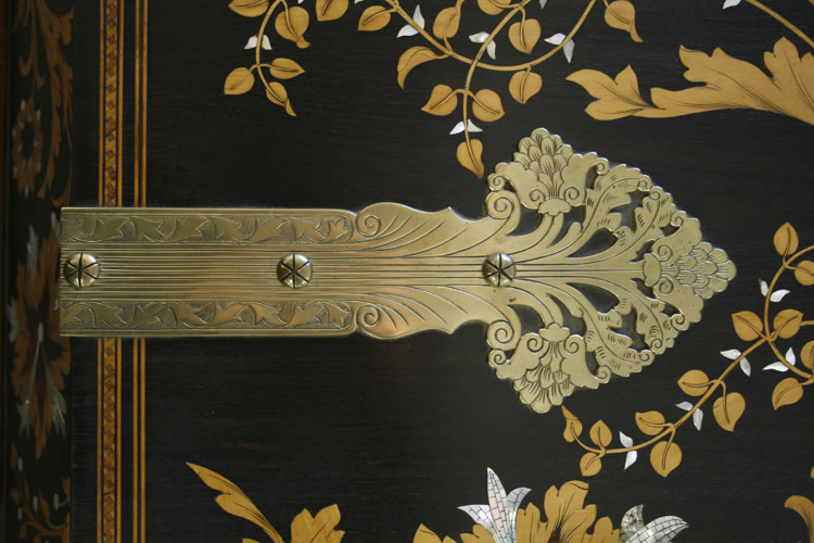 Ornate brass hinges
