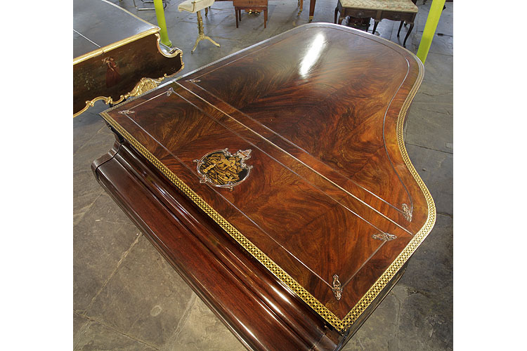 Schiedmayer piano lid in stunning, flame mahogany with a pagoda style chinese scene in embossed black Japanning. Entire lid encircled in gilt trellis decoration.