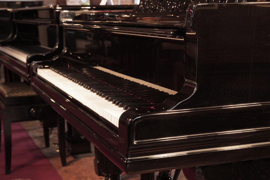 Steinway Model A serpentine piano cheek   with dual linear case moulding that wraps around the base of the cabinet