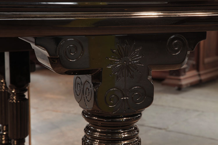 Piano pediment carved with a stylised flower and curlicues
