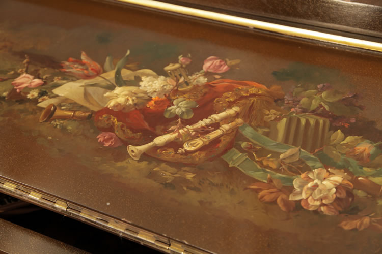 Hand-painted still life on the underside of the piano lid featuring flowers, draped fabric and musical instruments