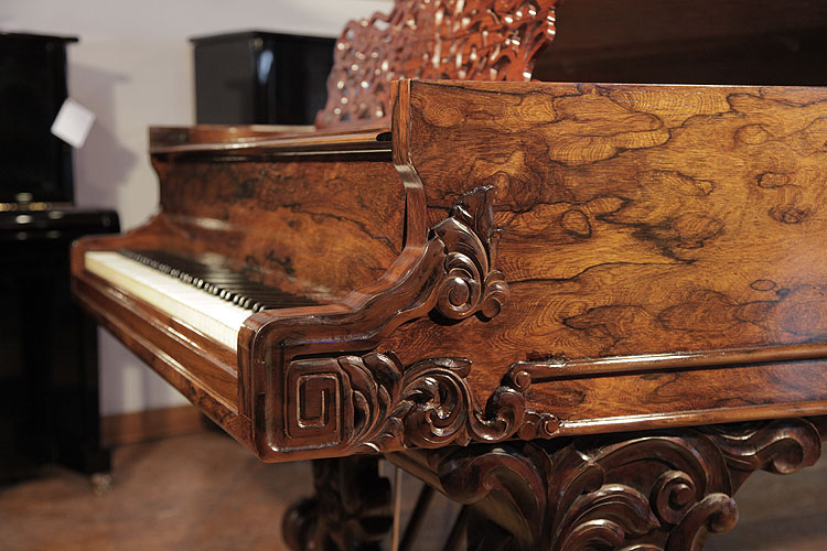 Steinway Model D piano cheek detail featuring a Classical meander and carved acanthus in high relief