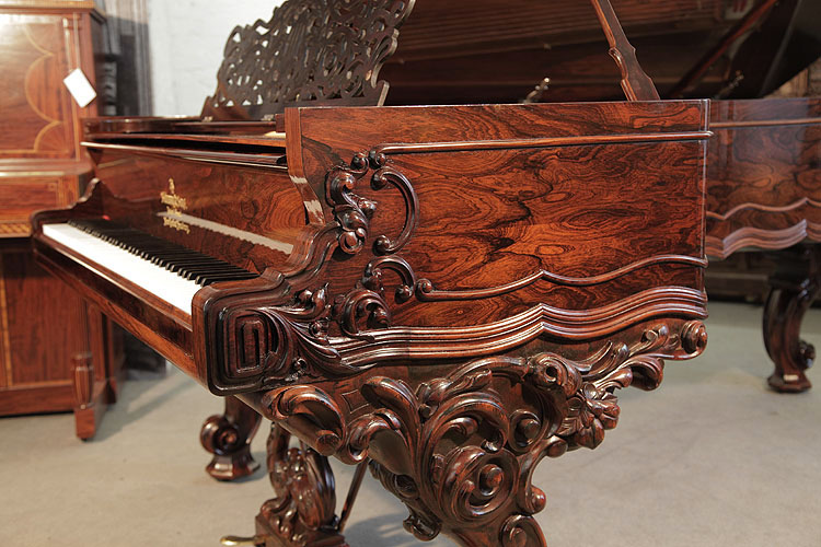 Steinway Centennial concert grand serpentine, piano cheek detail featuring a Classical meander, C-scrolls and and carved acanthus in high relief