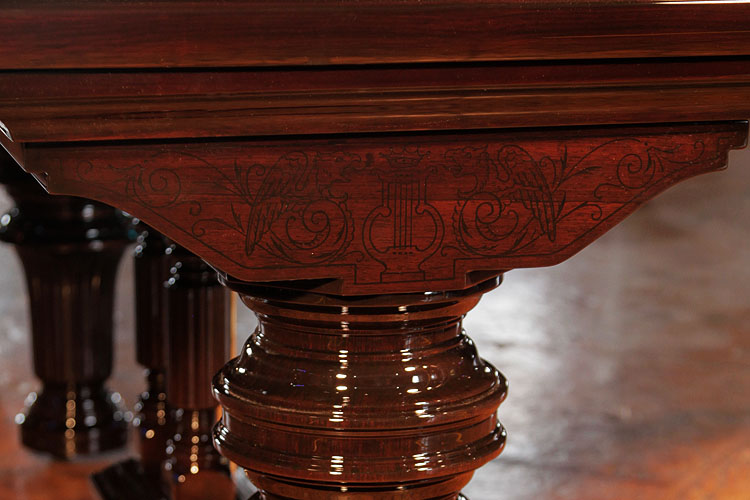 Steinway piano leg pediment carved with two facing griffins and a central lyre adorned with a crown