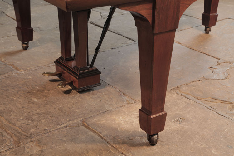 Steinway piano cheek with linear case moulding ending in a curlicue