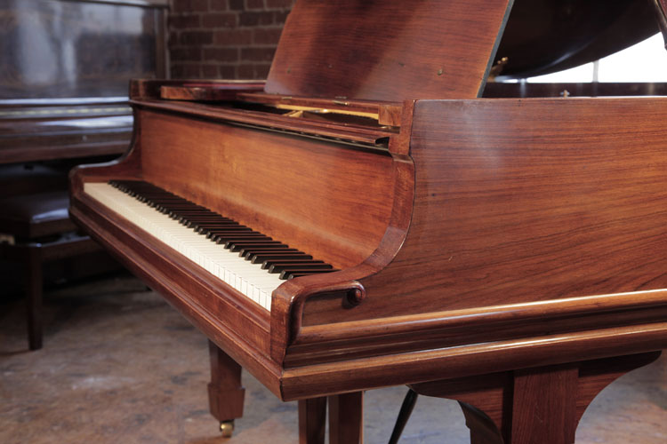 Steinway piano cheek and linear case moulding ending in a classical meander