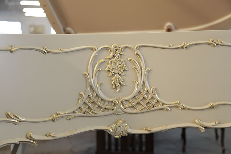 Steinway Model O cabinet featuring Rococo style carvings of flowers, scrolling foliage and latticework with gilt accents