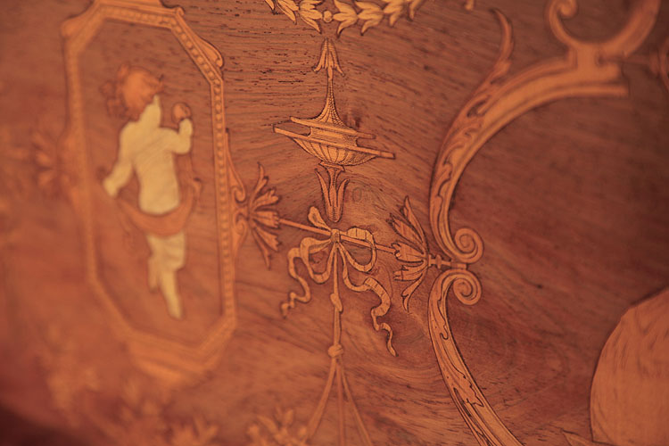 Detail of inlay featuring a central bow and urn