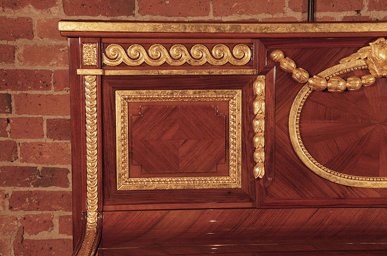 Steinway square, side panel in quartered walnut with a gold beaded surround. Pilaster features gold strapwork with a floral embellishment