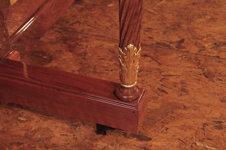 Steinway leg detail featuring carved acanthus leaves in gold