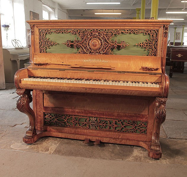 An 1855c, Brinsmead upright piano with a birch case and carved cabriole legs. Cabinet features intricate, fretwork front panels. Formerly the property of English music hall performer and male impersonator, Vesta Tilley