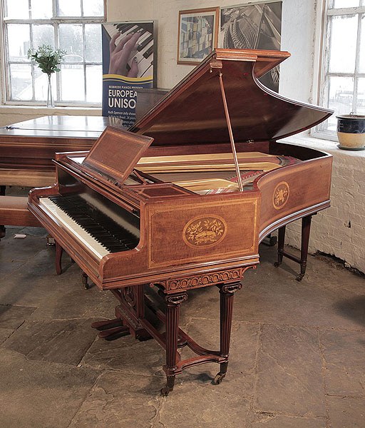 Reconditioned, 1894, Broadwood grand piano with a fiddleback mahogany case and tapered fluted legs attached with a cross stretcher 