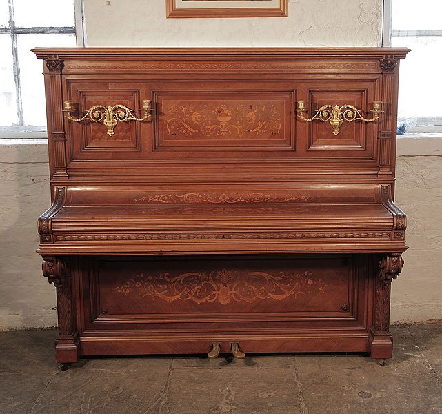 Albert Gast upright piano for sale with a quartered, walnut case and ornate, brass candlesticks