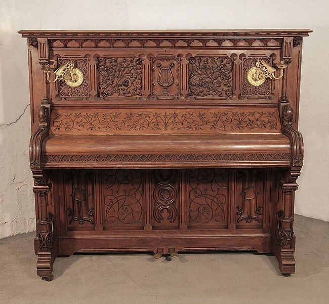 Renaissance style, Gebruder Knake upright piano for sale with an ornately carved, oak case. Cabinet features front panels carved with arabesque style, flowers, foliage and a central lyre. Renaissance style, Gebruder Knake upright piano for sale with an ornately carved, oak case. Cabinet features front panels carved with arabesque style, flowers, foliage and a central lyre.