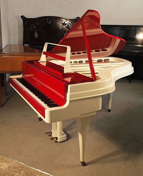 A 1959, Rippen grand piano with a contrasting cherry polyester and painted aluminium case. This Rippen piano has a beautiful slimline outline and minimal openwork music desk. Piano features a reverse crown soundboard and tapered legs. Piano has an eighty-eight note keyboard and a two-pedal piano lyre. A 1959, Rippen grand piano with a contrasting cherry polyester and painted aluminium case. This Rippen piano has a beautiful slimline outline and minimal openwork music desk. Piano features a reverse crown soundboard and tapered legs. Piano has an eighty-eight note keyboard and a two-pedal piano lyre.