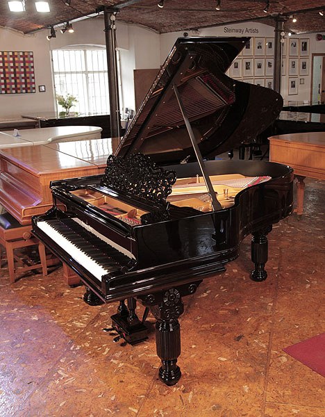 Rebuilt, 1883, Steinway Model A grand piano for sale with a black case, filigree music desk and fluted, elephant legs