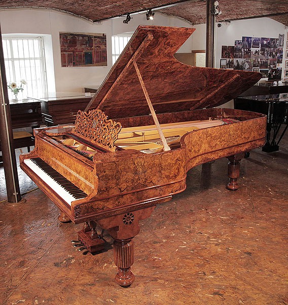 Rebuilt 1881, Steinway & Sons Model D concert grand piano with a burr walnut case, filigree music desk and fluted, barrel legs.  