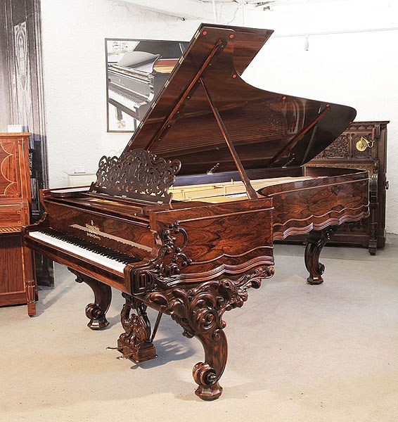 Rebuilt, 1874, Steinway & Sons centennial concert grand piano for sale with a rosewood case, filigree music desk and ornately carved, reverse scroll legs 
