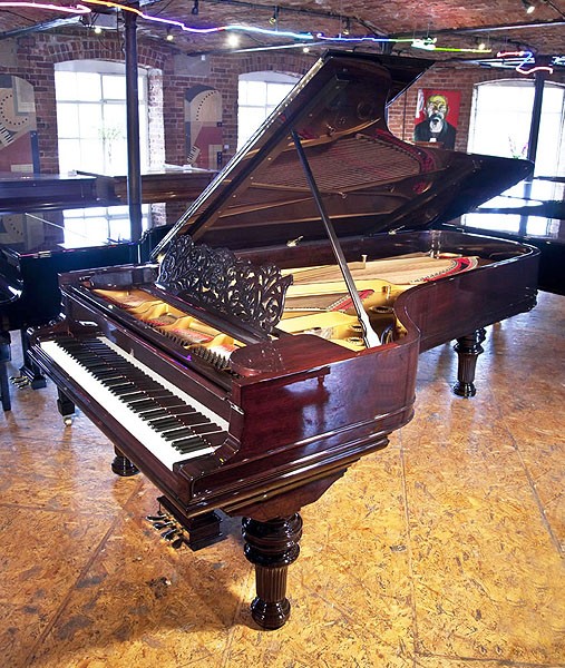 A rebuilt, 1886, Steinway & Sons Model D concert grand piano with a rosewood case, filigree music desk and turned, fluted legs 
