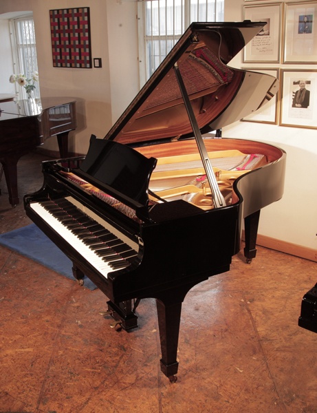 Rebuilt, 1975, Steinway Model O grand piano with a black case and spade legs. Piano has an eighty-eight note keyboard and a two-pedal lyre. 