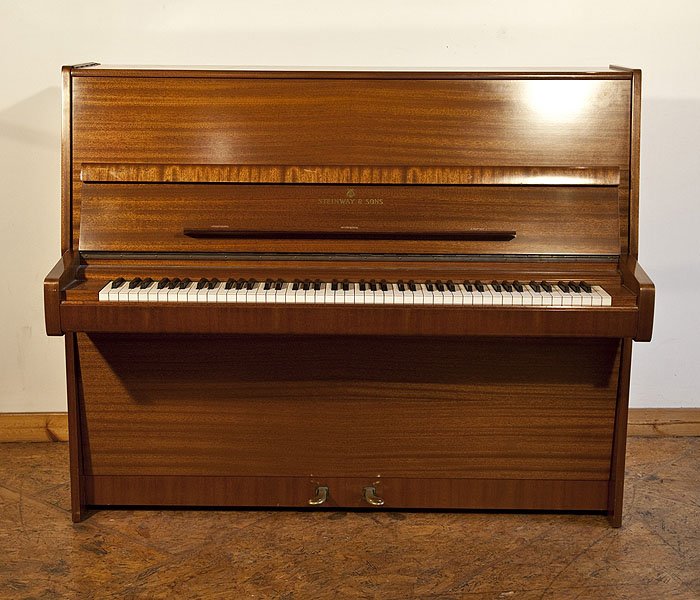 A 1975, Steinway Model V upright piano with a polished, mahogany case
