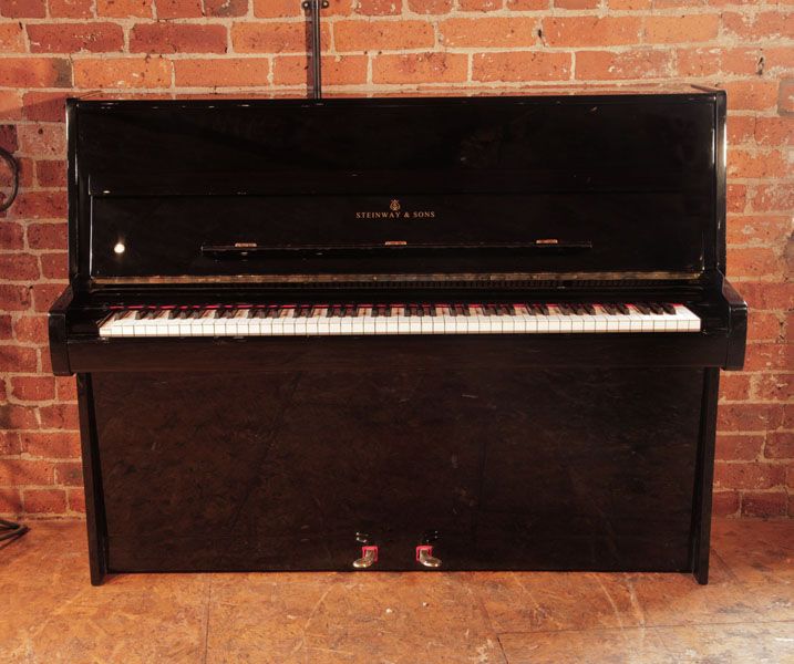 Reconditioned, 1981, Steinway Model Z upright piano with a black case and brass fittings