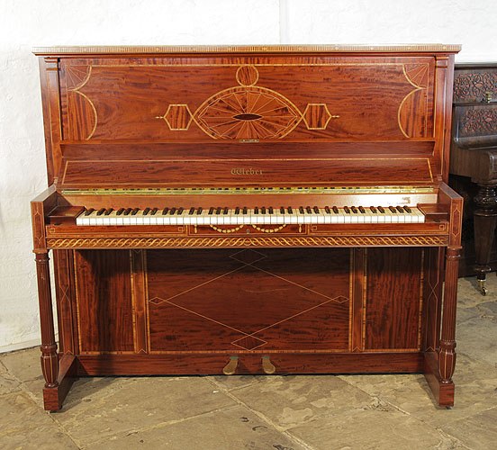 Golden age of pianos. A 1912, Weber upright piano for sale with a flame mahogany case and turned, fluted legs. Cabinet inlaid with a stylised, Neoclassical design featuring geometric forms in a variety of woods.